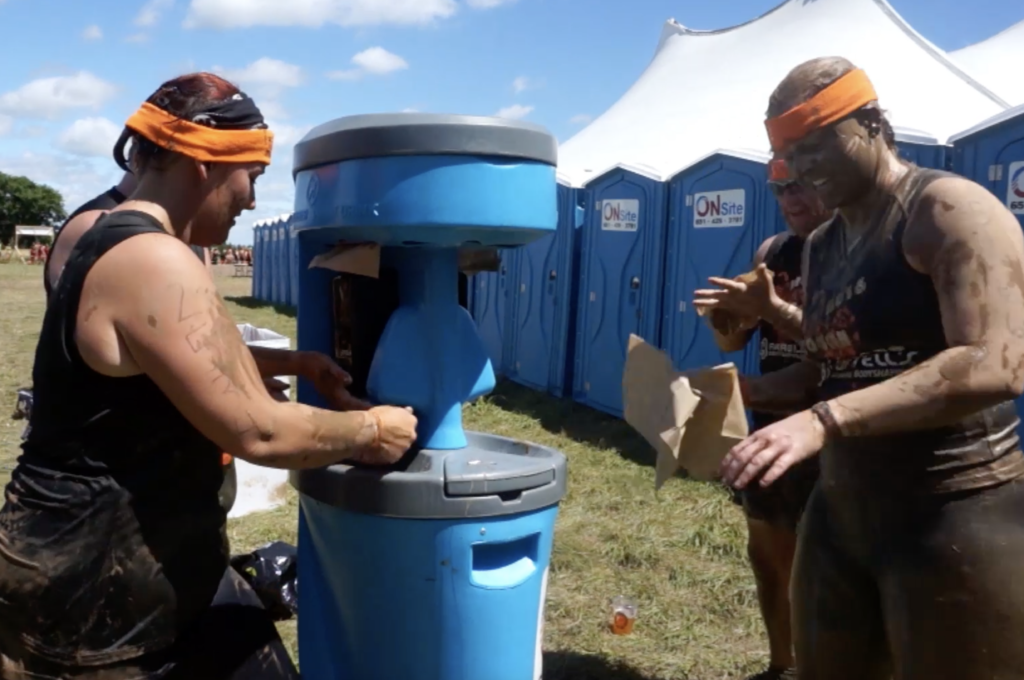 People washing hands with portable sink